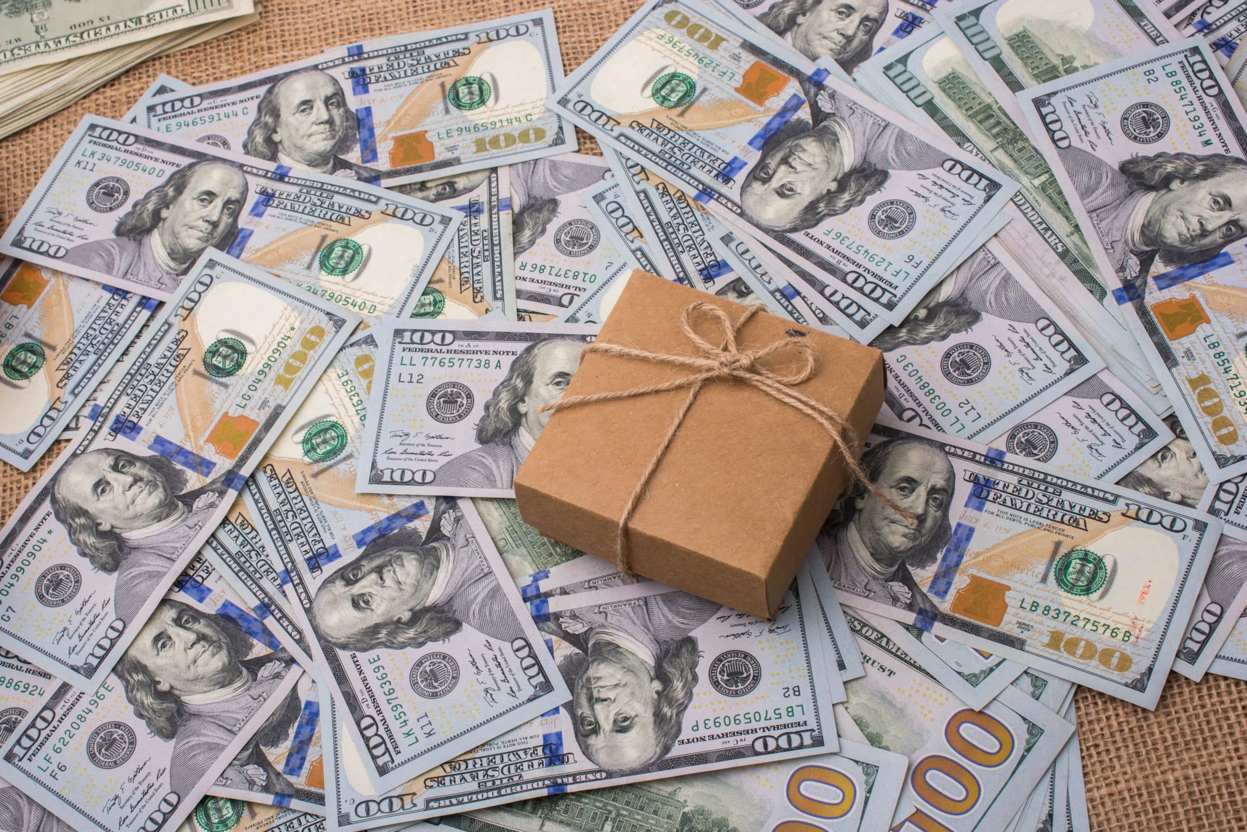 Gift box surrounded by cash