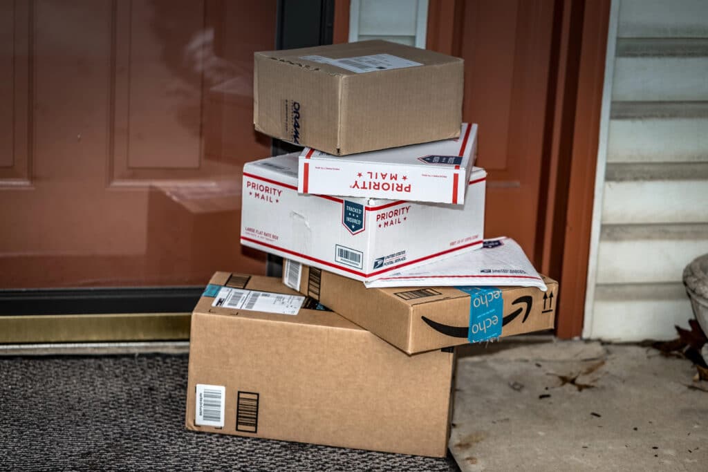 stack of shipping boxes by front door
